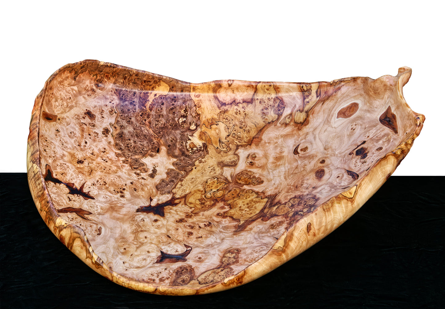 Fancy and irregular 22.5” long maple platter-like bowl sculpted from spalted maple. It has twisted and figured burl patterns, bird's-eye patterns, and rich colors of tan, brown, and gold with a hint of red, 215-A