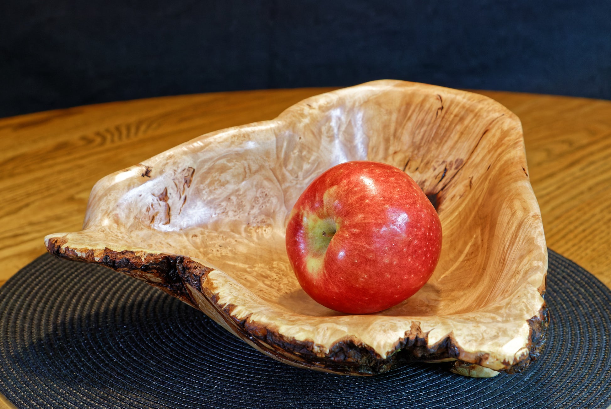 Hard maple bowl, beautiful fancy figuring, live edge, bark, golden brown, with red apple.