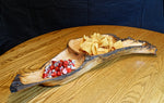Front left view of a 2-part wooden Ponderosa pine bowl, platter, charcuterie board.  Rustic yet smooth, with live edge.  It is holding candy and chips and is 26.5" long x 11.5 x 4'' tall, and weighs 4.1 lbs., wild elegance.