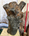 Very early stage in carving a wooden 32" tall black walnut floor sculpture with white chalk markings showing some of the wood that will be saved, some that may be removed, and a red yardstick. 