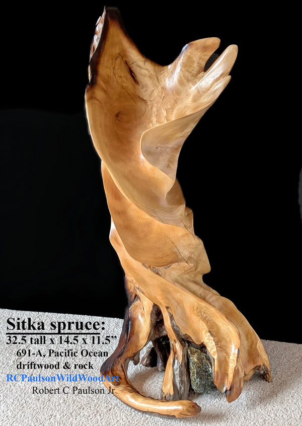 33" tall freeform Sitka spruce wooden sculpture, golden orange, tan and brown colors on a black background. One-of-a-kind exotic, twisting floor or tabletop sculpture with a flared top, some live edge enhancements and a natural rock in the base.  Created from Pacific Ocean driftwood.  It has beautiful and exotic grain patterns with rich natural colors.  The art piece measures 32.5 tall x 14.5 x 11.5’’, 20.1 lbs. 