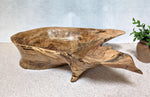 Wooden bowl with natural edge design on a light surface. Front view of figured maple wooden irregular bowl, smooth and soft with beautiful grain patterns, intriguing clear epoxy-filled fine cracks and rich natural colors (no stains or artificial colors added).  It measures 6 tall x 23 x 16’’, 5.8 lbs. 