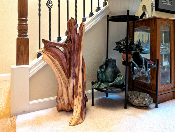 Twisted, free flowing natural wood sculpture, Utah juniper with beautiful grain patterns, one-of-a-kind floor or tabletop .  It measures 27 tall x 13.25 x 12’’, 15 lbs.  Wooden sculpture on a staircase with decorative elements