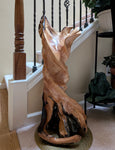 Wooden sculpture on a staircase with a neutral background