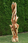 Possible front view of a tall and twisted wood sculpture, rich looking one-of-a-kind 7' 3" tall by 22.5" x 22'' natural western juniper floor sculpture that emphasizes the tree's natural form and beauty.  It has some live edge design and is a combination of smooth surfaces with beautiful grain patterns and and a few slightly rough areas.  Some preserved insect holes show its past visitors.