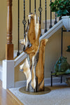36.7" tall twisted floor sculpture displayed beside a home's staircase. One-of-a-kind exotic,  It was created from Pacific Ocean driftwood.  It has beautiful and exotic grain patterns with rich natural golden orange, tan, brown, black and gray colors (no stains or artificial colors).  The art piece measures 36.7 x 14.5 x 12.25'', 21.87 lbs.  RC Paulson Wildwood Art