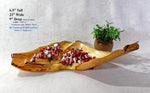Wooden serving dish with decorative items on a white background